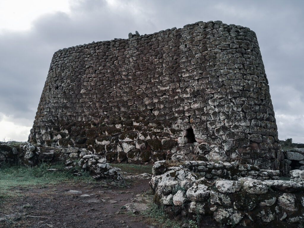 Monumentale Nuraghe auf Sardinien, fotografiert von außen unter wolkenverhangenem Himmel